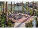 Cozy community fire pit surrounded by Adirondack chairs and mature landscaping at 17386 Blazing Star Cir, Clermont, FL 34714