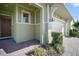 Inviting front entrance featuring a brown door, neat landscaping, and a brick-paved walkway to the garage at 17386 Blazing Star Cir, Clermont, FL 34714