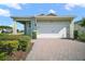Charming single-story home showcasing a brick driveway, attached garage, and beautifully landscaped front yard at 17386 Blazing Star Cir, Clermont, FL 34714
