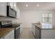 Kitchen featuring granite counters, stainless appliances, and ample counter space at 17386 Blazing Star Cir, Clermont, FL 34714