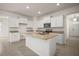 Open kitchen with granite countertops, stainless appliances, and white cabinetry at 17386 Blazing Star Cir, Clermont, FL 34714