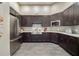 This kitchen features stainless steel appliances, dark cabinetry, and ample counter space for culinary enthusiasts at 17386 Blazing Star Cir, Clermont, FL 34714