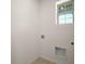 Neutral laundry room showcasing the hookups for your laundry machines at 17386 Blazing Star Cir, Clermont, FL 34714