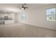 Inviting living area seamlessly flows into a kitchen featuring granite countertops and modern appliances at 17386 Blazing Star Cir, Clermont, FL 34714