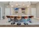 This lounge features a stunning bar area with modern pendant lighting, sleek counter seating, and dual televisions at 17386 Blazing Star Cir, Clermont, FL 34714