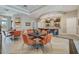 This lounge boasts a cozy and inviting atmosphere with its stylish furnishings, herringbone floors, and well-stocked bar area at 17386 Blazing Star Cir, Clermont, FL 34714