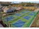 Community pickle ball courts surrounded by palm trees and well maintained landscaping at 17386 Blazing Star Cir, Clermont, FL 34714