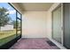 Screened patio features brick flooring, sliding glass doors, and views of the backyard and lush landscaping at 17386 Blazing Star Cir, Clermont, FL 34714