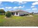 This home has a lovely backyard with immaculate landscaping, shrubbery, and healthy green lawn at 1902 Del Norte Dr, Lady Lake, FL 32159
