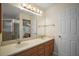 Bathroom featuring a double sink vanity, a large mirror, and a walk-in shower at 1902 Del Norte Dr, Lady Lake, FL 32159