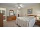 Comfortable bedroom with a large dresser and a decorative mirror creating a cozy ambiance at 1902 Del Norte Dr, Lady Lake, FL 32159