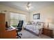 Bedroom featuring a desk area, a comfortable twin bed, and a bright window at 1902 Del Norte Dr, Lady Lake, FL 32159