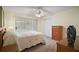 Bright bedroom featuring a large window, closet, dresser and plush carpeting at 1902 Del Norte Dr, Lady Lake, FL 32159