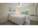 Bright bedroom featuring large window and neutral-toned decor at 1902 Del Norte Dr, Lady Lake, FL 32159