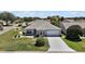 Charming single-story home featuring a well-manicured lawn and a decorative driveway at 1902 Del Norte Dr, Lady Lake, FL 32159