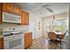 Bright kitchen features wood cabinetry, matching appliances, and a cozy breakfast nook at 1902 Del Norte Dr, Lady Lake, FL 32159