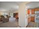 Inviting living room with plush carpeting, ceiling fan, and open access to the kitchen at 1902 Del Norte Dr, Lady Lake, FL 32159