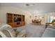 Spacious living room with built-in entertainment center, adjacent to the dining area at 1902 Del Norte Dr, Lady Lake, FL 32159