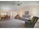 Comfortable living room with neutral tones, vaulted ceiling, and open flow to dining space at 1902 Del Norte Dr, Lady Lake, FL 32159