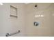 Clean shower featuring convenient shelving and a grab bar for added safety at 1902 Del Norte Dr, Lady Lake, FL 32159