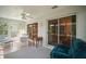 Bright sunroom with ceiling fan, neutral colors, and sliding glass doors to the outdoor spaces at 1902 Del Norte Dr, Lady Lake, FL 32159
