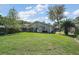 Spacious backyard featuring a well-maintained lawn, shed, and privacy fence at 20 Ginger Cir, Leesburg, FL 34748