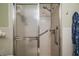 Clean and accessible bathroom featuring a glass-enclosed shower with safety grab bars for added convenience at 20 Ginger Cir, Leesburg, FL 34748