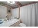 Stylish bathroom with marble countertop and a decorative shower curtain offering a modern and refreshing design at 20 Ginger Cir, Leesburg, FL 34748