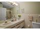 Well-lit bathroom features double sinks and modern fixtures, perfect for a clean and functional space at 20 Ginger Cir, Leesburg, FL 34748