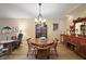Formal dining room features hardwood floors, elegant lighting, and classic china cabinet perfect for entertaining at 20 Ginger Cir, Leesburg, FL 34748