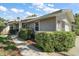 Charming one-story home with a well-maintained lawn and mature shrubbery along the walkway at 20 Ginger Cir, Leesburg, FL 34748
