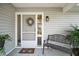 Welcoming front porch with a stylish bench and charming wreath creates a cozy and inviting entrance to the home at 20 Ginger Cir, Leesburg, FL 34748