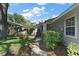 Landscaped front yard with a walkway leading to a gray one-story home on a sunny day at 20 Ginger Cir, Leesburg, FL 34748
