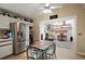 Eat-in kitchen featuring stainless steel refrigerator and open view into bonus room at 20 Ginger Cir, Leesburg, FL 34748