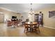 Spacious living room with hardwood floors, chandelier, and plentiful seating arrangements at 20 Ginger Cir, Leesburg, FL 34748