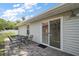 Charming backyard patio with a table and chairs accessible from sliding glass doors at 20 Ginger Cir, Leesburg, FL 34748