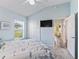 Light-filled bedroom with closet and access to living spaces; features a ceiling fan and an exterior window at 2006 Oppenheimer Ct, The Villages, FL 34762