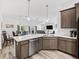 Open-concept kitchen with bar seating overlooking a living and dining area, perfect for entertaining guests at 2006 Oppenheimer Ct, The Villages, FL 34762
