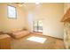 Bedroom with high ceilings, large windows, and a stone fireplace offering a bright and comfortable living space at 2112 Robie Ave, Mount Dora, FL 32757