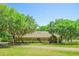 Charming single-story home with mature trees, lush landscaping, and a long driveway at 2112 Robie Ave, Mount Dora, FL 32757