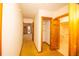 Hallway view showing access to another room, a closet, and a bathroom with a tub and toilet at 2112 Robie Ave, Mount Dora, FL 32757