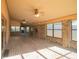 Enclosed patio with brick flooring, ceiling fans, and ample windows, providing a bright and airy space at 2112 Robie Ave, Mount Dora, FL 32757