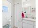 Bright half-bath with white vanity and tile floors at 21707 Queen Mary Ct, Leesburg, FL 34748