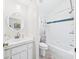 Clean bathroom with a white vanity, toilet, and shower-tub combo at 21707 Queen Mary Ct, Leesburg, FL 34748