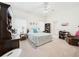 Bright bedroom with a ceiling fan, a desk and chair, and a bookshelf at 21707 Queen Mary Ct, Leesburg, FL 34748