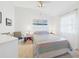 Bright bedroom featuring a ceiling fan and an ocean-themed art piece at 21707 Queen Mary Ct, Leesburg, FL 34748