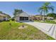 Charming home with a well-kept lawn, mature trees, a spacious driveway, and a convenient garage at 21707 Queen Mary Ct, Leesburg, FL 34748