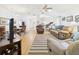 Open living space featuring hardwood floors, neutral furniture, and an open concept connecting to the kitchen and dining area at 21707 Queen Mary Ct, Leesburg, FL 34748