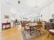 Spacious living room and dining area with natural lighting, laminate flooring, and an open floor plan at 21707 Queen Mary Ct, Leesburg, FL 34748