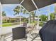 Relaxing screened porch with an outdoor dining area and grill, with backyard views and plenty of seating at 21707 Queen Mary Ct, Leesburg, FL 34748